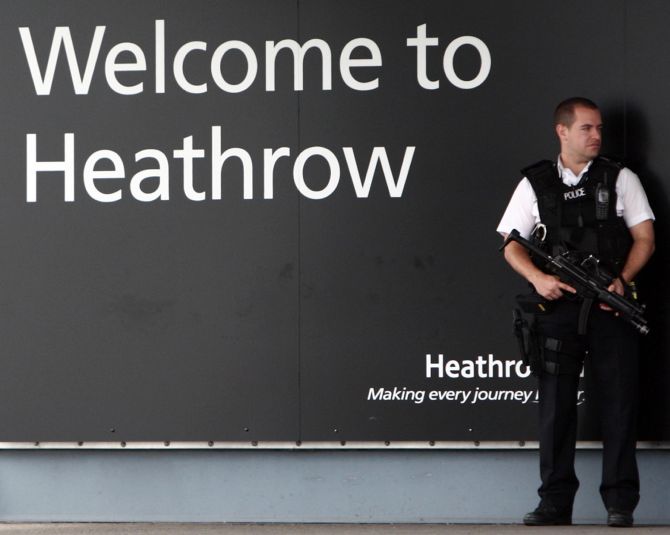 A security guard stands at the entrance of the Heathrow airport in London. Security was beefed up after the terror attack. 