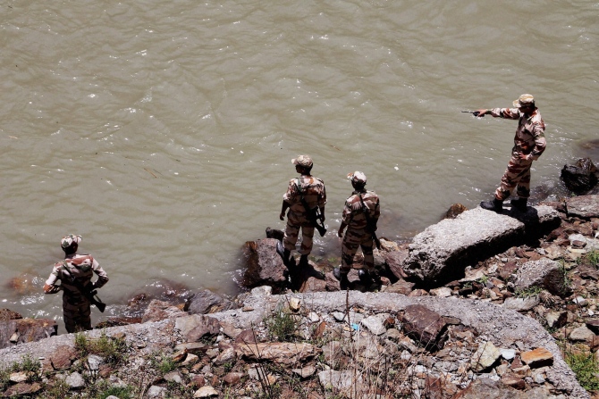 NDRF personnel carry out a rescue operation in Beas River near Pandoh Dam in Mandi on Monday