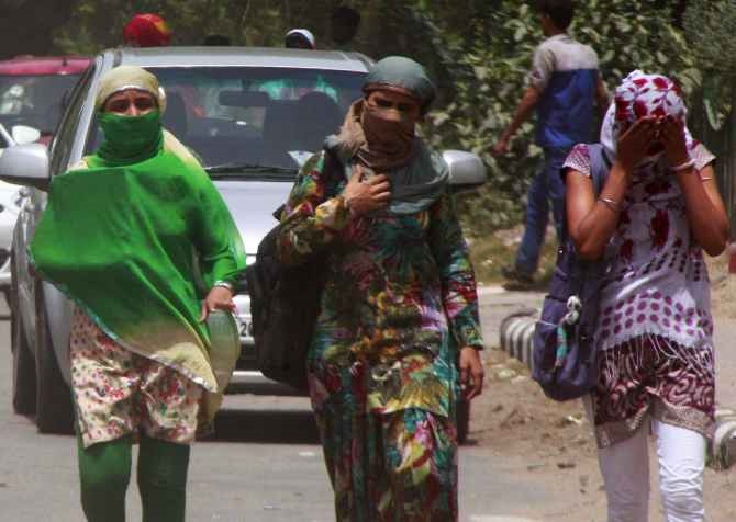 College girls cover their faces to beat the heat in Gurgaon