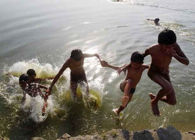 Boys take a splash in the Ganga on a hot day in Allahabad