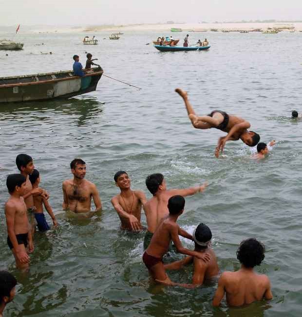 A group of youngsters have fun as they cool off in the Ganga at Varanasi