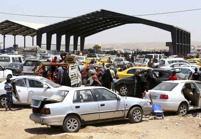 Families fleeing the violence in Mosul arrive at a checkpoint in outskirts of Erbil