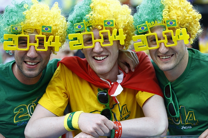Brazil fans celebrate before the opening match of the 2014 World Cup between Brazil and Croatia in Curitiba