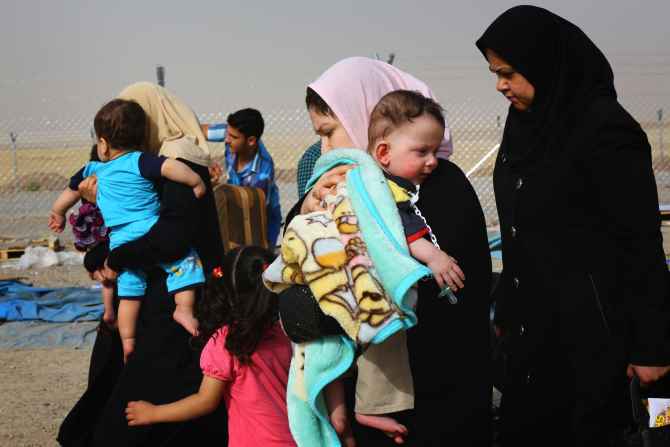 Families fleeing the violence in Mosul arrive at a checkpoint on the outskirts of Erbil on Thursday