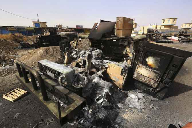 Burnt vehicles belonging to Iraqi security forces are pictured at a checkpoint in east Mosul two days after ISIL fighters took over the city
