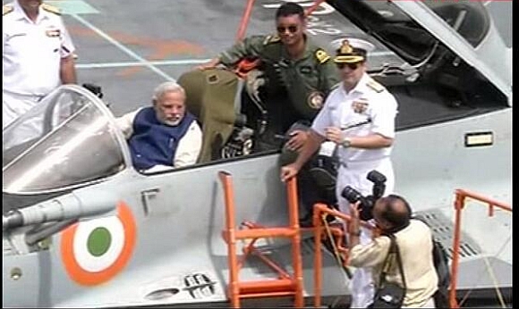 Modi sits in a MiG 29K jet on board INS Vikramaditya 