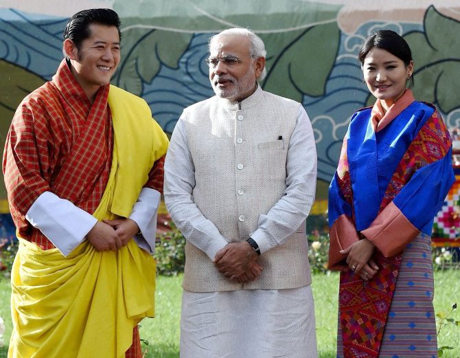 Modi poses for a photograph with Bhutanese King Jigme Khesar Namgyel Wangchuk and his wife Jetsun Pema in Thimpu