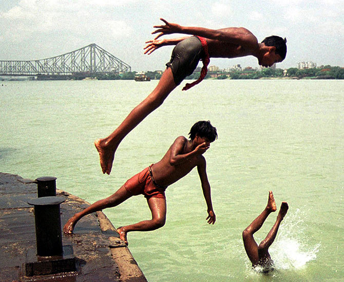 Hoping to seek some respite from the heat, boys take a dip in the Ganga.