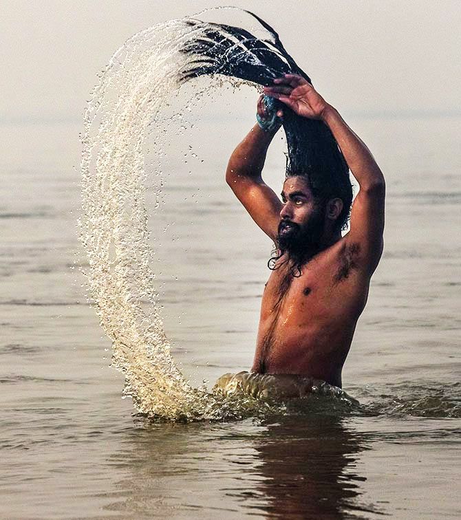 A sadhu takes a dip in the Ganga. Photograph: Daniel Berehulak/Getty Images