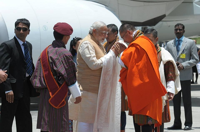 Modi being received by Prime Minister Tshering Tobgay of Bhutan at Paro International Airport