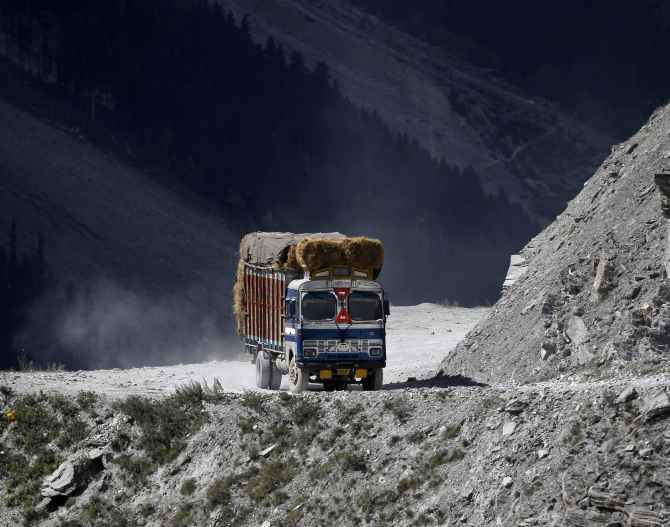 A truck drives on a mountainous road near Zojila in Ladakh