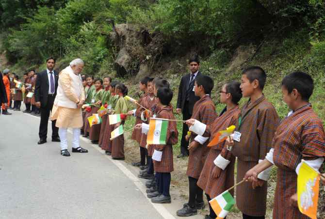 Prime Minister Narendra Modi meeting children who lined up waving flags to wish him goodbye along the road to the airport, in Thimphu