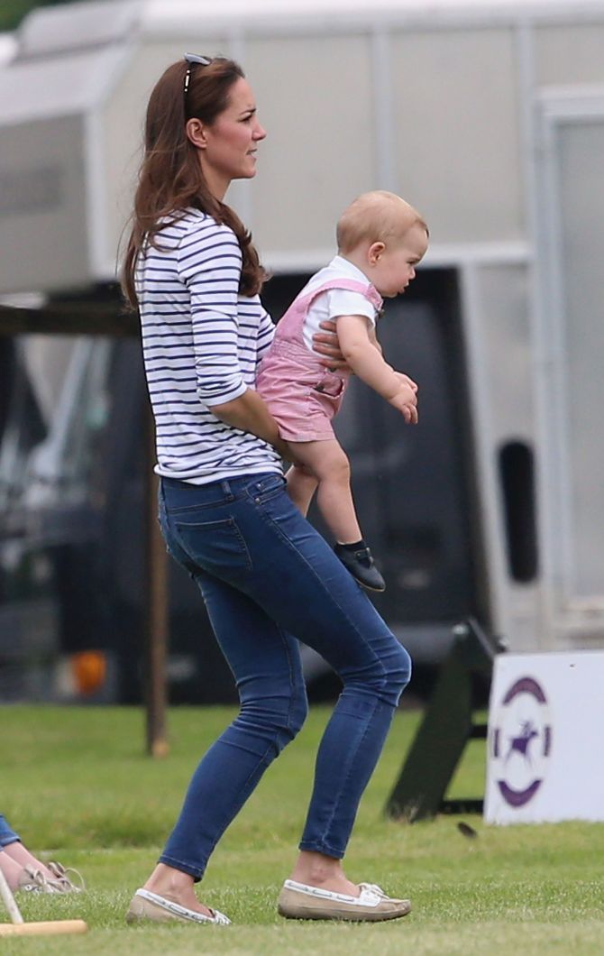 Prince George wriggles in his mother's arms trying to break free.