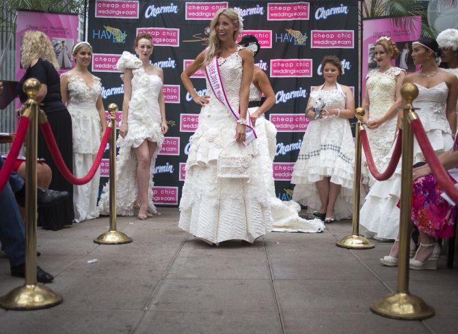 Women display the various wedding dressed made from tissue paper