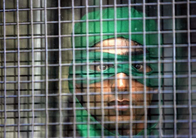 A detaineGreenpeace activist dressed as a turtle in a protest in Mumbao 