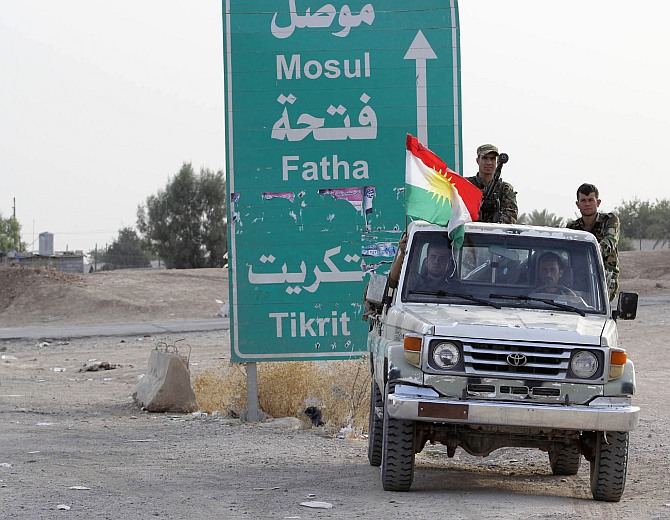 Members of the Kurdish security forces take part in an intensive security deployment on the outskirts of Kirkuk