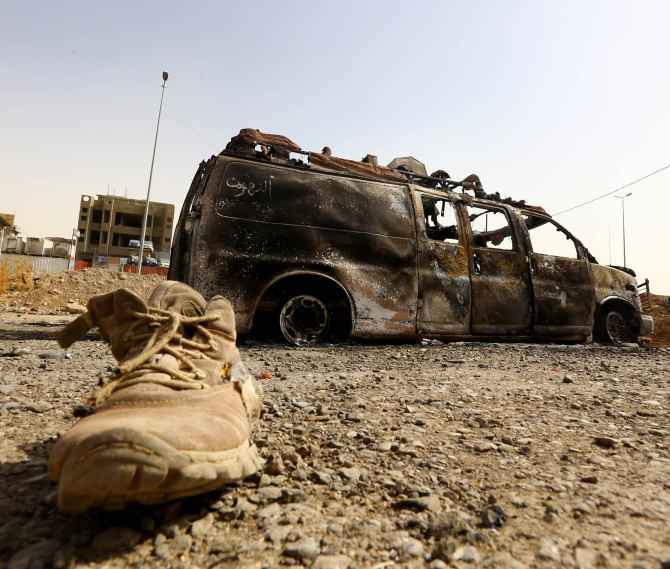 A burnt vehicle belonging to Iraqi security forces at a checkpoint in east Mosul which was taken over by ISIS fighters