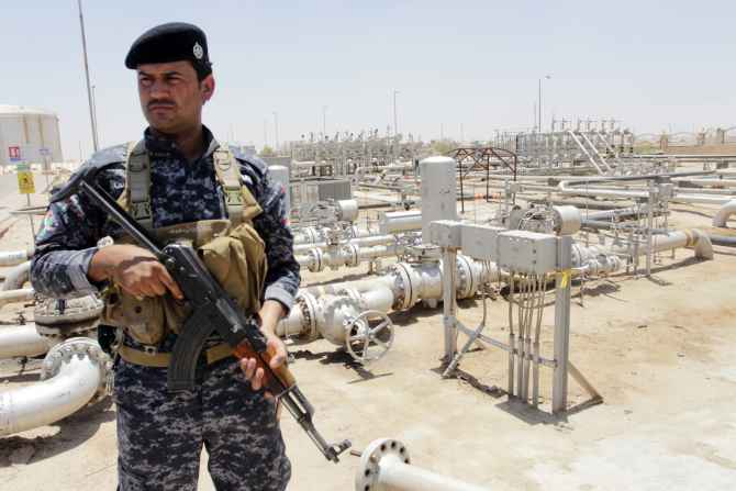 A member from the oil police force stands guard at Zubair oilfield in Basra, Iraq