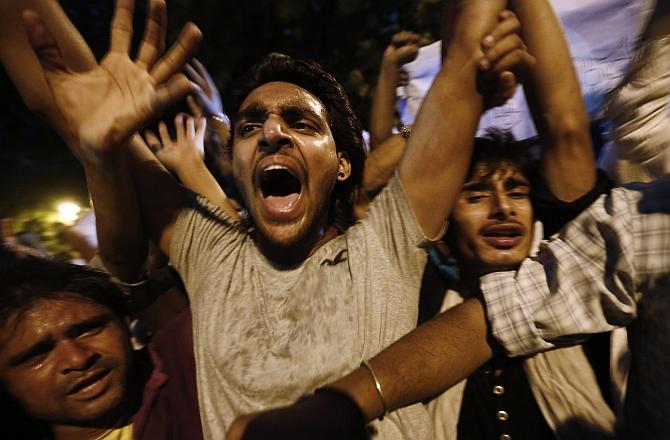 Shiite Muslims take part in a protest against the ongoing conflict in Iraq, in New Delhi