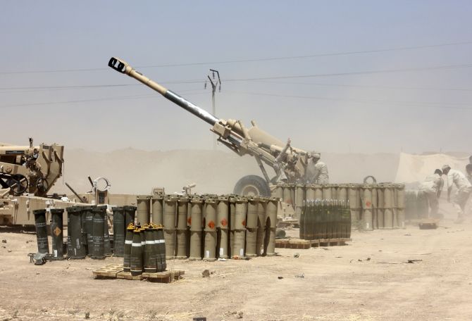 Iraqi security forces fire artillery during clashes with Sunni militant group Islamic State of Iraq and the Levant on the outskirts of the town of Udaim in Diyala province.