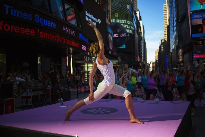 People practice yoga in Times Square as part of a Summer Solstice celebration in New York