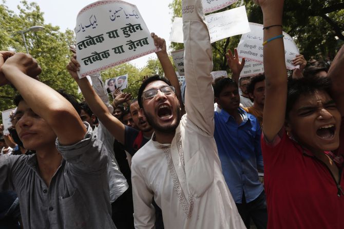 Indians chant protests against the violence and brutality by the ISIS militants in Iraq.