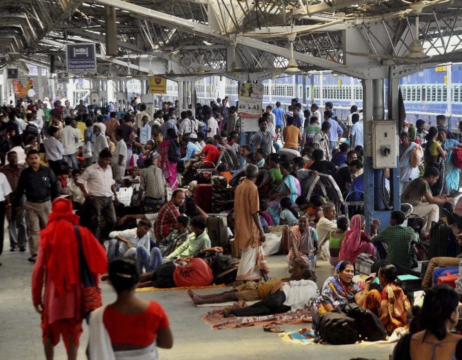 Stranded passengers wait at the platform after the train derailed near Chhapra