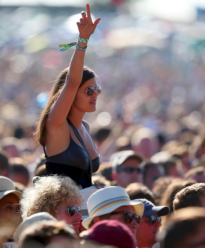 Music fans cheer a band performing on the Other Stage at the Glastonbury Festival of Contemporary Performing Arts site at Worthy Farm