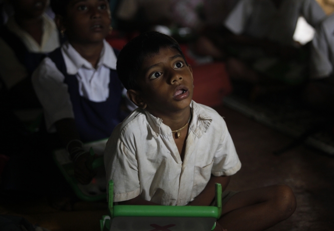 A school boy uses a laptop provided under the One Laptop Per Child' project by a non-governmental organisation, in a state-run primary school, on the eve of International Literacy Day at Khairat village, about 90 km from Mumbai.