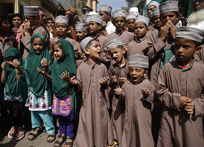 Muslim children pray for rain on a street in Mumbai