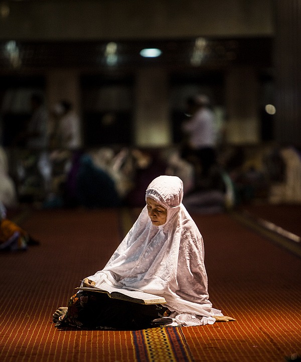 An Indonesian Muslim reads the Quran during prayers known as Tarawih at Istiqlal Mosque, the largest mosque in Southeast Asia.
