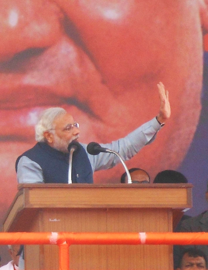 BJP PM nominee waves to supporters as he addresses a rally in Lucknow
