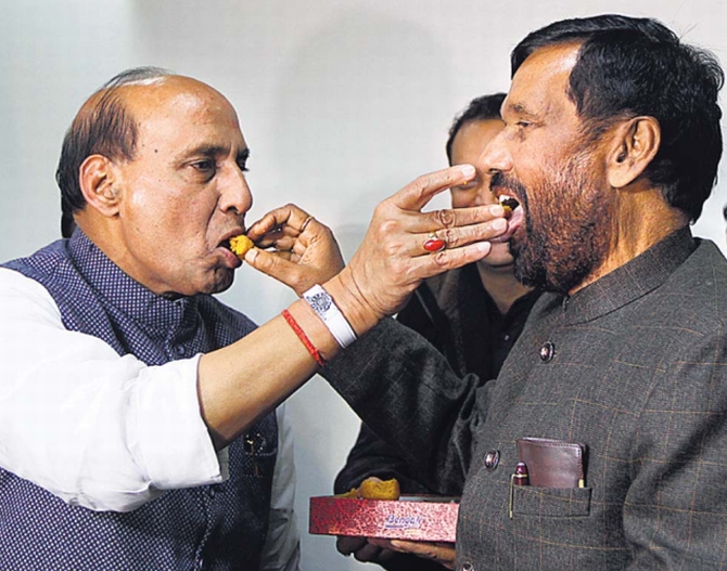 BJP chief Rajnath Singh and LJP leader Ram Vilas Paswan celebrate after they formed an alliance for the Lok Sabha elections