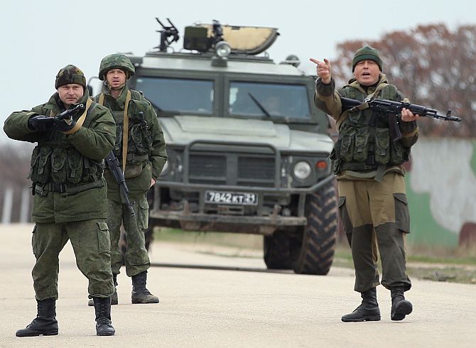 Troops under Russian command, before firing weapons into the air at an approaching group of over 100 unarmed Ukrainian troops at the Belbek airbase, which the Russian troops are occcupying, in Crimea.