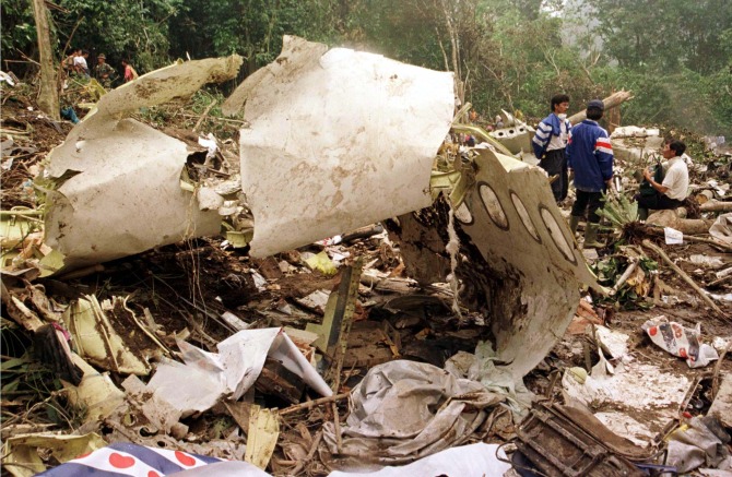 Rescue workers near the torn fuselage of the Garuda Airlines Airbus A300 which crashed into heavy jungle near Medan in Sumatra.
