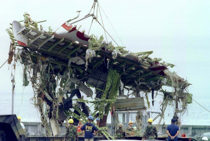A large section of fuselage from TWA Flight 800 is lifted to shore from a navy barge August 3 at the Shinnecock Coast Guard station.