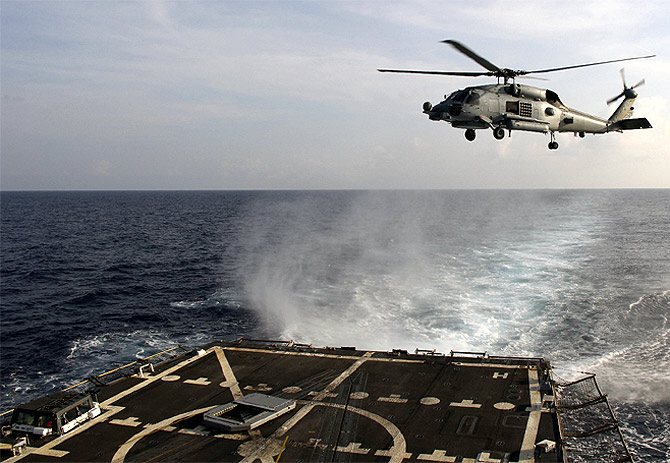 A US Navy SH-60R Seahawk helicopter takes off from the destroyer 'USS Pinckney' in the Gulf of Thailand, to assist in the search