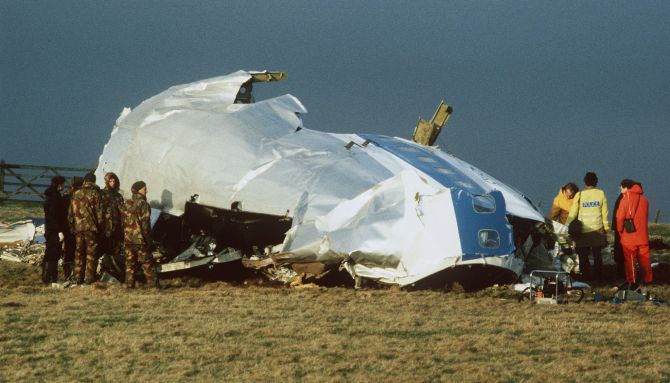 Scottish rescue workers and crash investigators search the area around the cockpit of Pan Am flight 103 in a farmer's field east of Lockerbie Scotland after a mid-air bombing killed all 259 passengers and crew, and 11 people on the ground