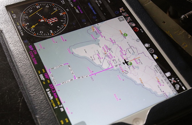 Search area is seen on an iPad of a military officer onboard a Vietnam Air Force AN-26 aircraft, during a mission to find the missing Malaysia Airlines flight MH370