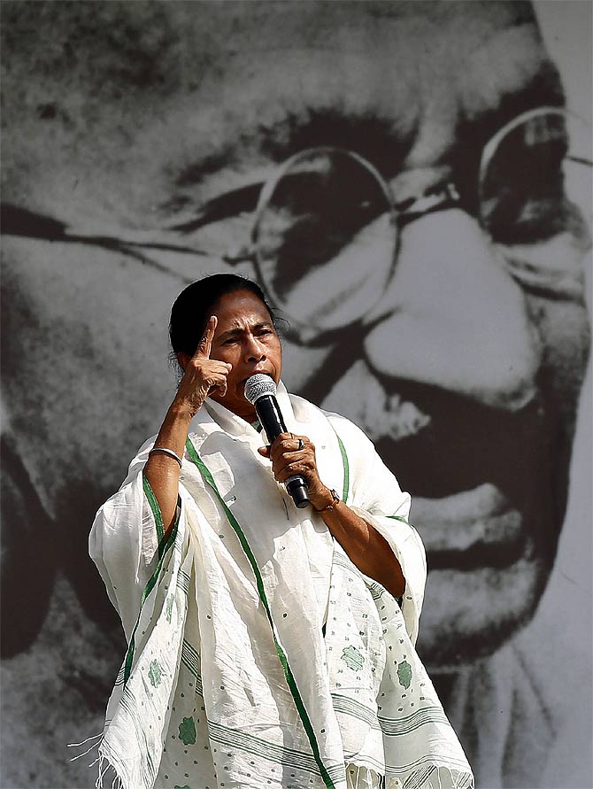 West Bengal CM addresses her supporters in front of a portrait of Mahatma Gandhi during a rally ahead of the 2014 general elections, in New Delhi March