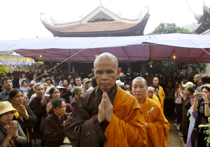 Buddhist monk Thich Nhat Hanh (centre), walks among believers after finishing a speech at the opening ceremony of a requiem mass at the Non Nuoc pagoda in Soc Son mountain, 64 km of Hanoi.