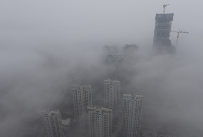 Buildings are seen shrouded in heavy haze at Qingdao development zone, Shandong province.