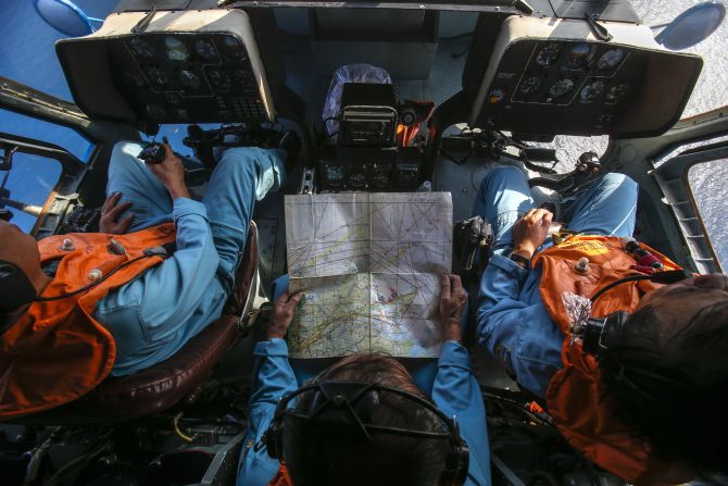 Military personnel work within the cockpit of a helicopter belonging to the Vietnamese airforce during a search and rescue mission off Vietnam's Tho Chu island 