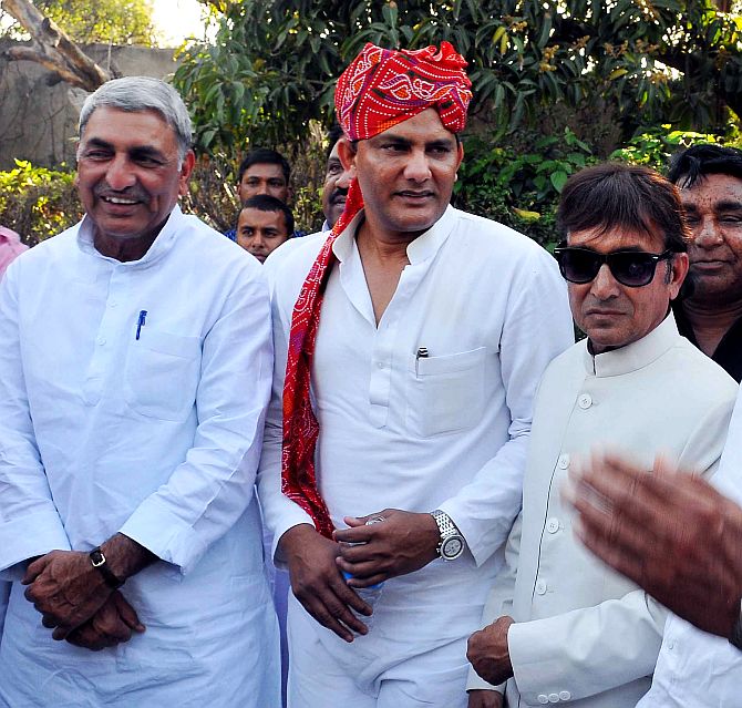 Azharuddin, donning a traditional Rajasthani pagdi, speaks to Congress leaders during a function in Jaipur