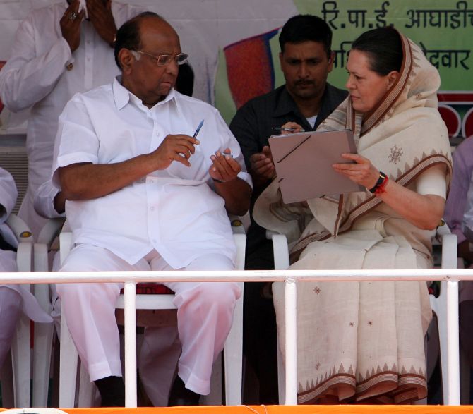 NCP chief Sharad Pawar speaks with Congress president Sonia Gandhi during a rally in Nagpur