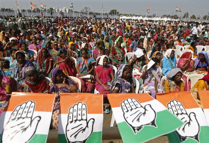 Supporters of the Congress party listen to Rahul Gandhi during a rally in Uttar Pradesh