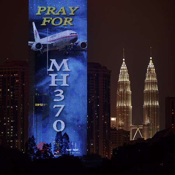 An electronic billboard displays a message about the missing Malaysian Airlines flight MH370