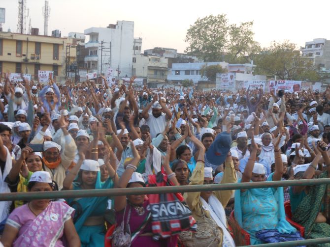 Supporters cheer for Arvind Kejriwal during AAP's rally in Varanasi on Tuesday