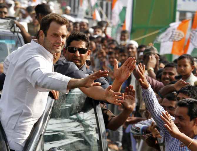 Rahul Gandhi greets supporters during a road show in Gujarat