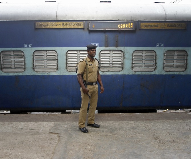 A policeman stands guard next to the passenger train in which two explosions occurred, at the railway station in Chennai